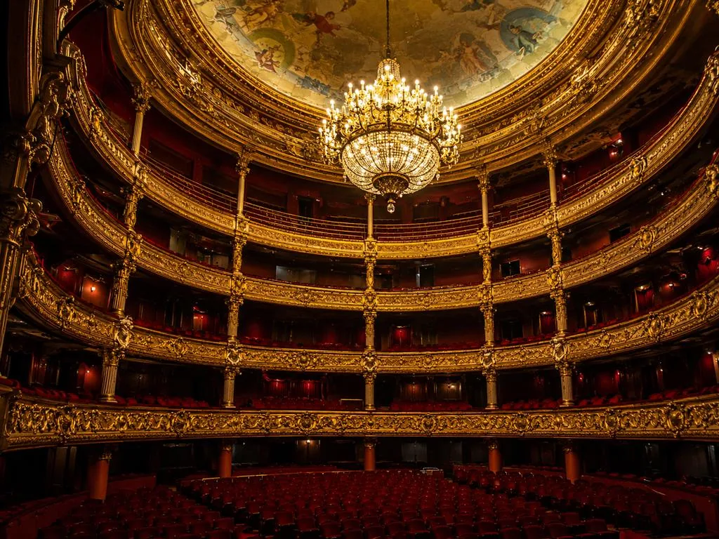The red-and-gold horseshoe auditorium of the Palais Garnier under its chandelier
