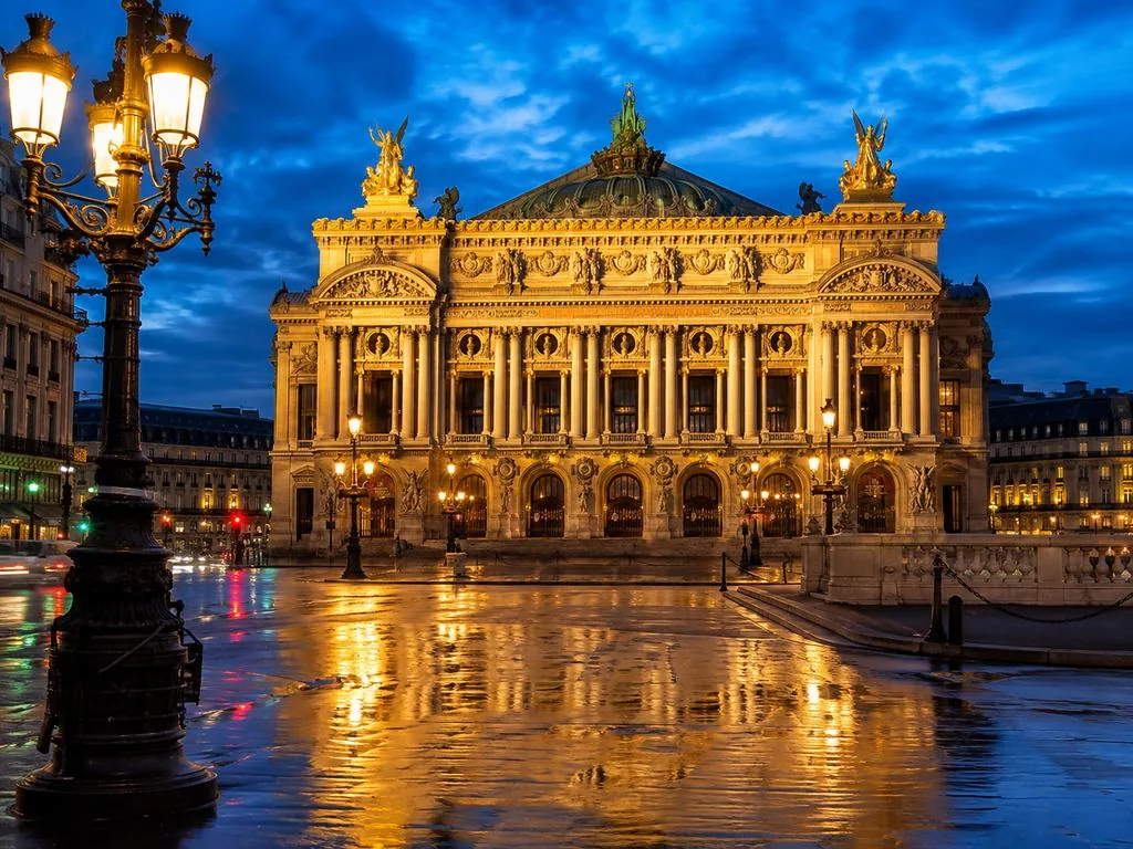 The Palais Garnier lit after dark on the Place de l’Opéra